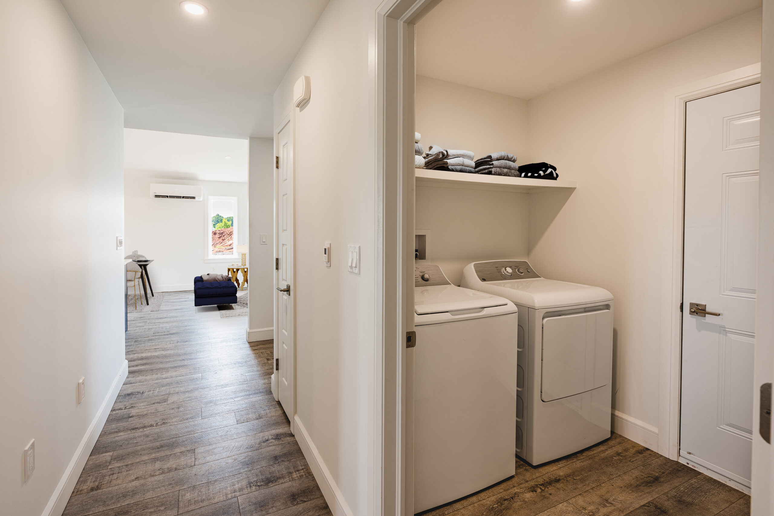 Laundry room and living room in the Delicious home, Valley Garden Home Collection
